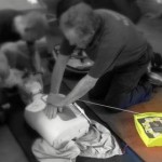 Members practising CPR with an AED.